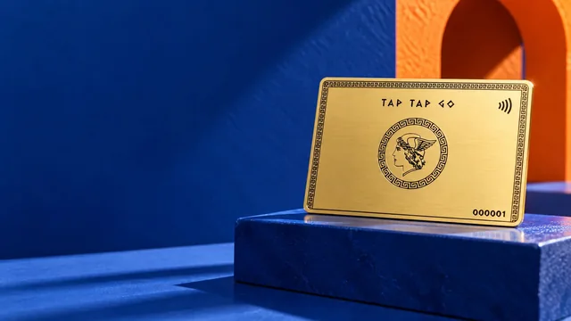 Tap Tap Go gold-finished card displayed on cobalt blue steps