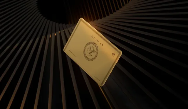 Tap Tap Go gold-finished card suspended within an architectural black studio
