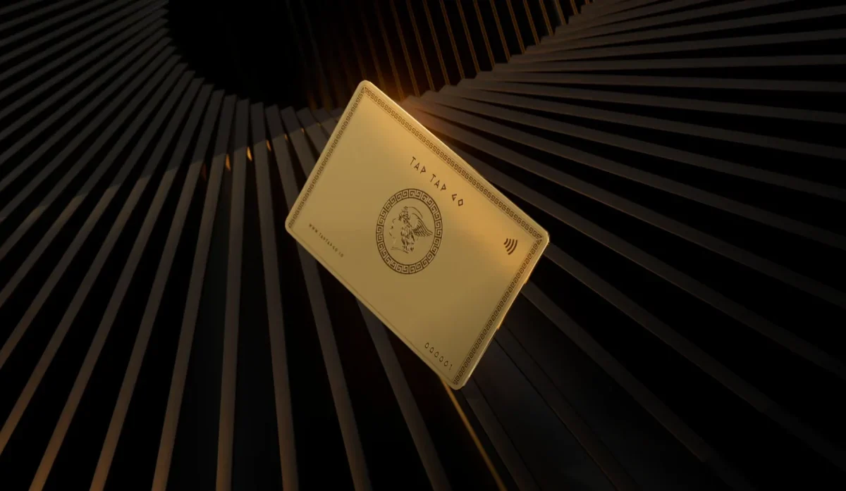 Tap Tap Go gold-finished card suspended within an architectural black studio