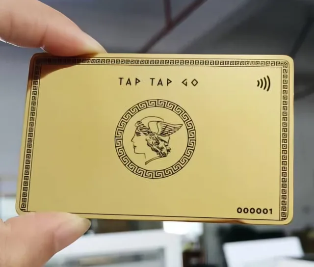 Close-up of the Tap Tap Go gold-finished card held in a hand